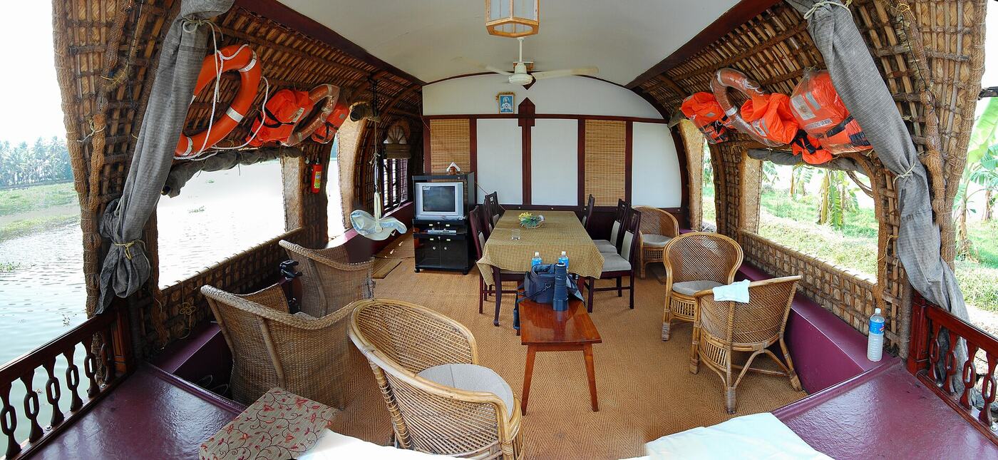 The cane-furnished front lounge of a Kerala houseboat