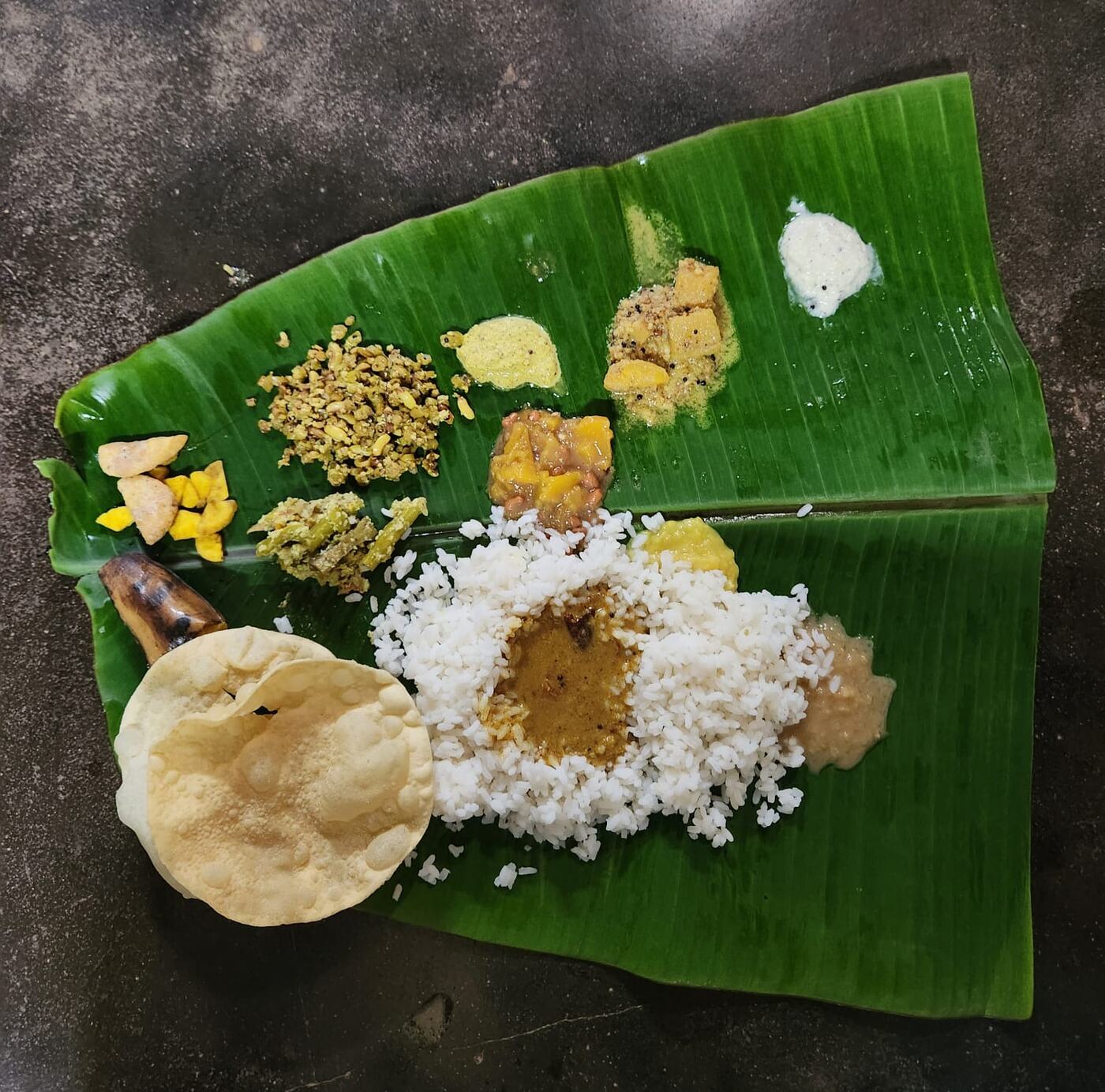 An Onam sadya served on a banana leaf